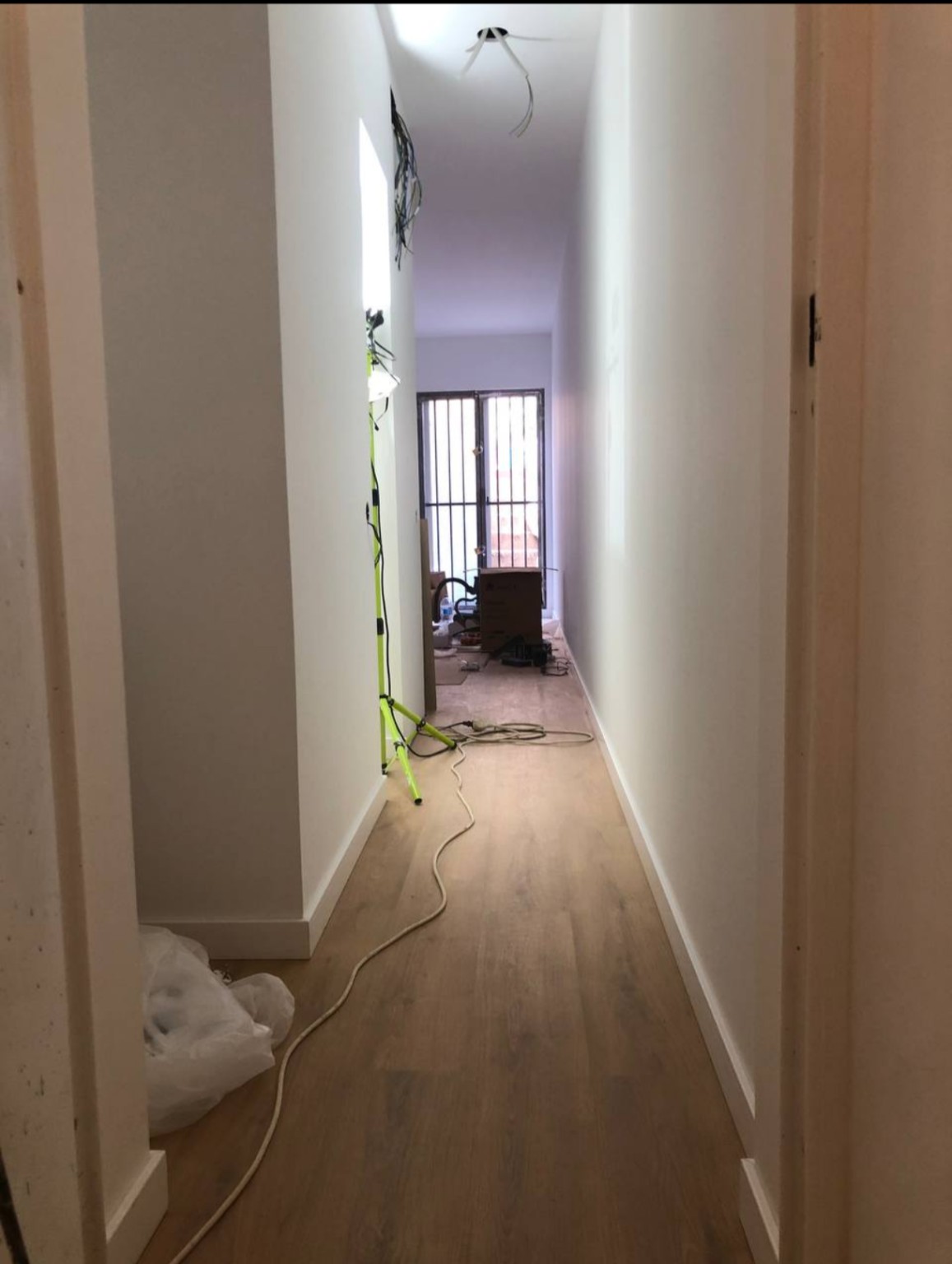 Floor covering and skirting installed in the first property's corridor