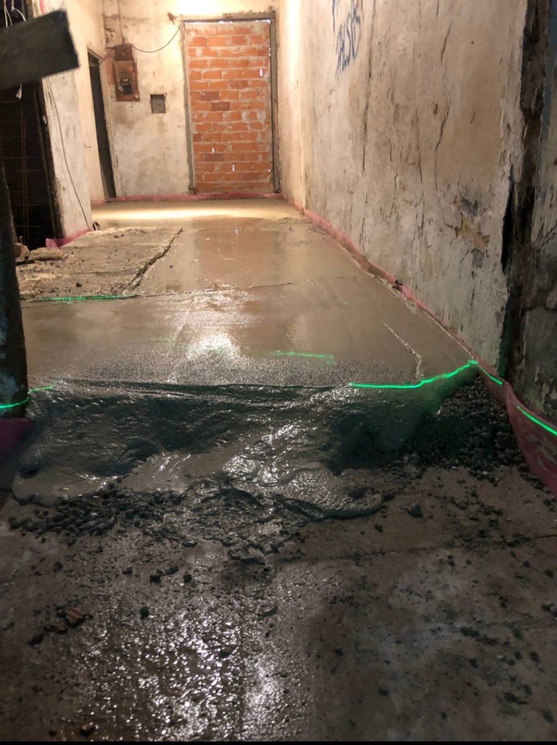 Floor leveling in progress with a visible laser line