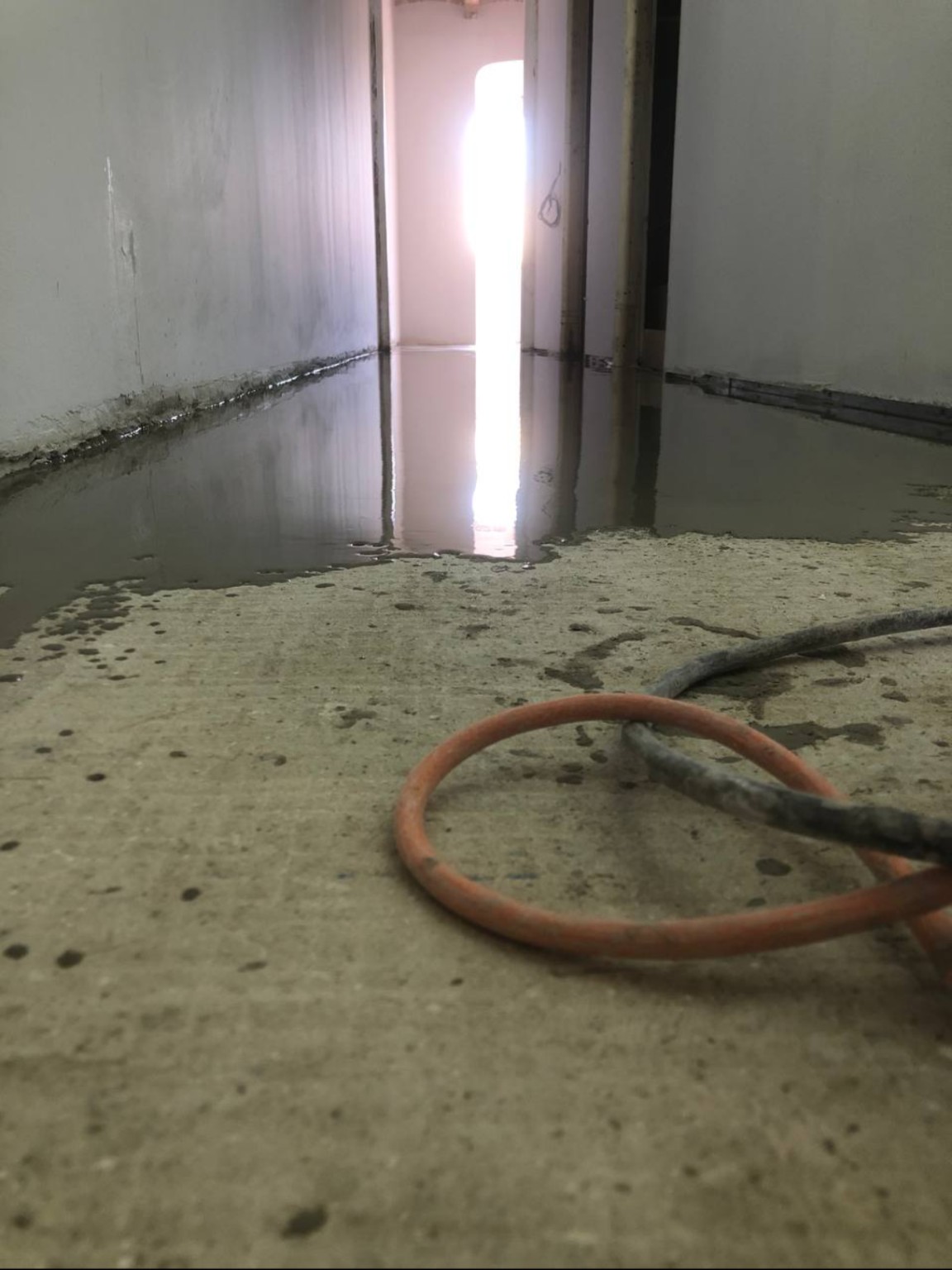 A thin self-leveling layer being applied at another property