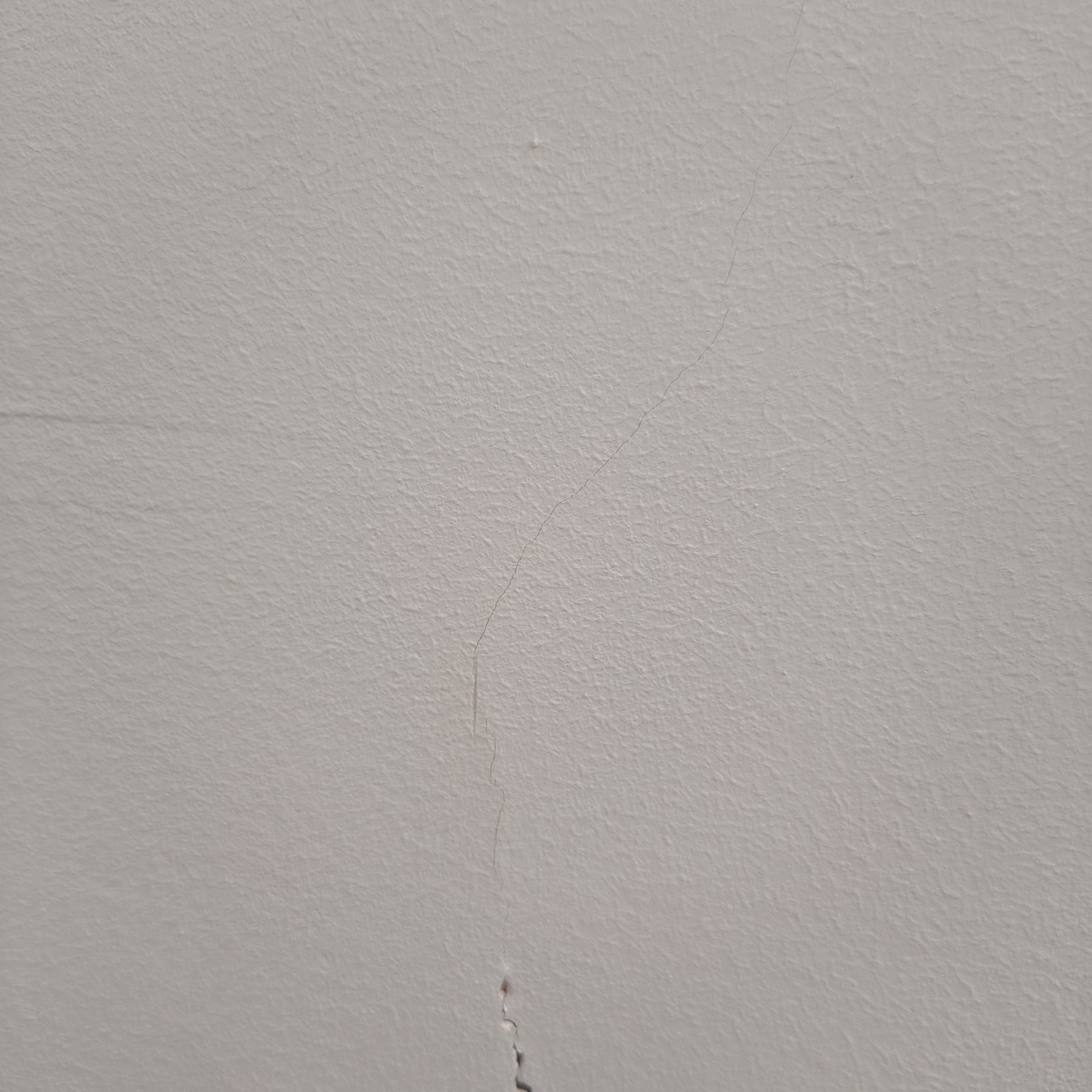 Fine crack visible in a painted wall