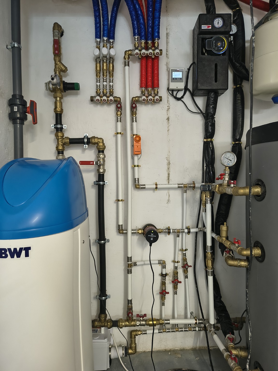Pipes, pumps, distribution manifolds and control equipment in a plant room
